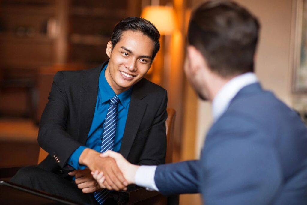 men shaking hands and smiling